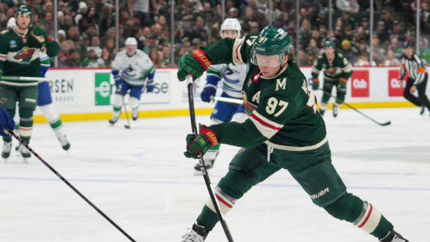 Feb 19, 2024; Saint Paul, Minnesota, USA; Minnesota Wild left wing Kirill Kaprizov (97) shoots against the Vancouver Canucks in the second period at Xcel Energy Center.